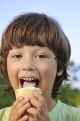 happy little boy eating an ice cream