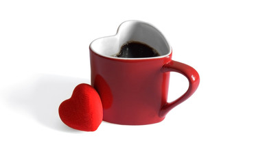 Heart shaped coffee mug dived in coffee beans, Valentines day.