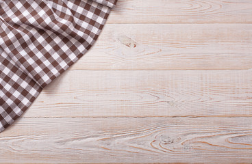 Top view of checkered tablecloth on white wooden table. © missty