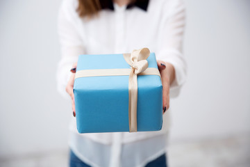 Closeup portrait of female hands holding gift