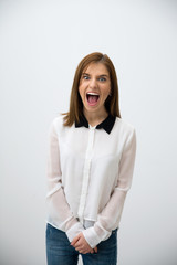 Angry businesswoman shouting over gray background