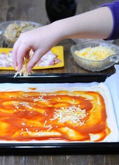Preparing homemade pizza.