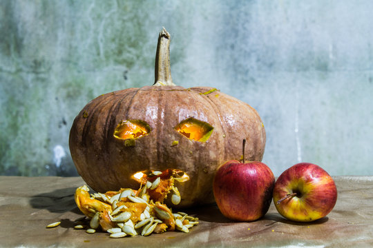 Haunted carved pumpkins for Halloween with apple