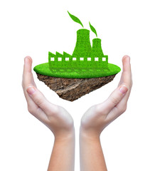 Small island with green nuclear power plant icon in hands
