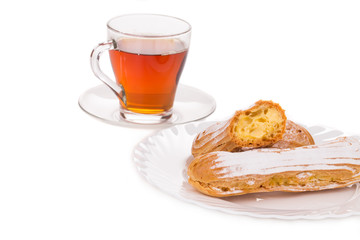 Cup of tea with eclairs