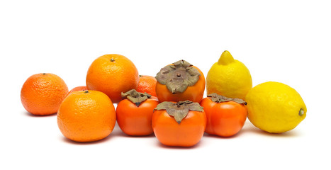 lemons, tangerines and persimmons isolated on white background c