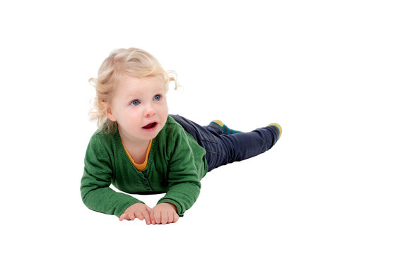 Adorable blond baby lying on the floor
