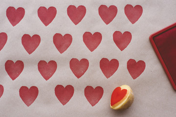 Fototapeta premium Objects: DIY wrapping paper decorated with heart shaped potato s