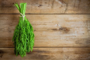 bunch of fresh organic dill on  wooden background