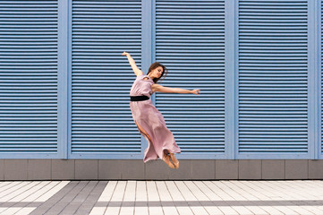 Ballerina dancing in casual clothes jumping on tiptoes