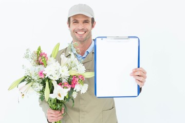 Happy delivery man holding bouquet and clipboard