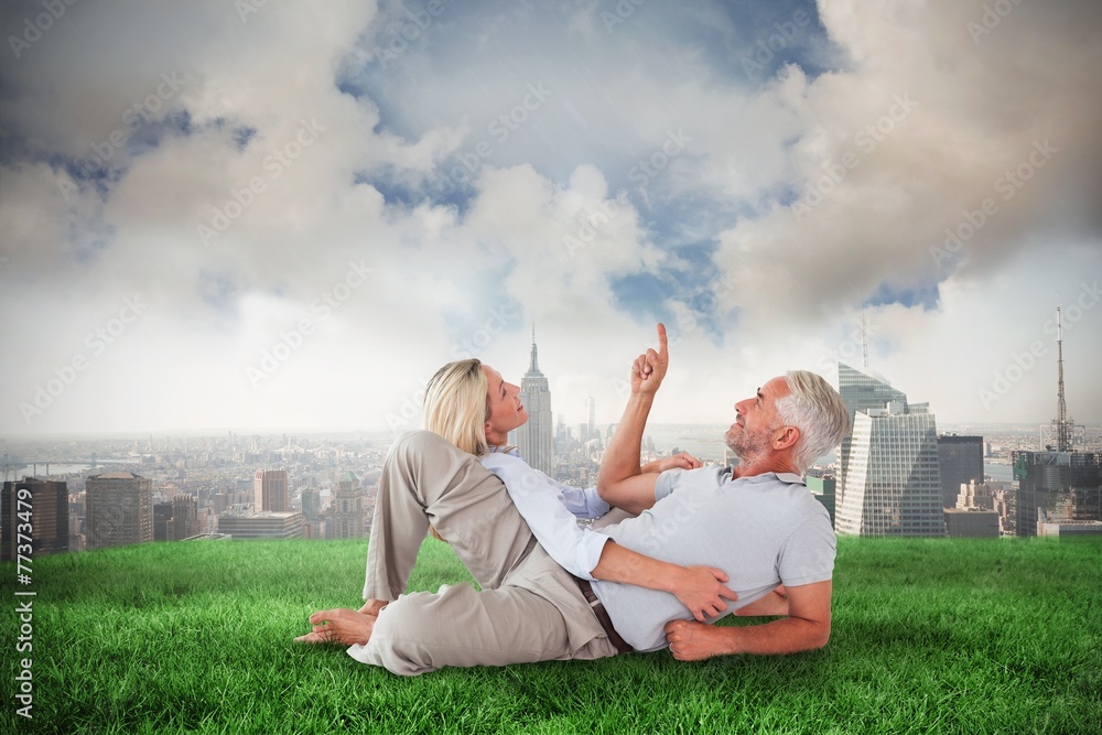 Poster Composite image of smiling couple lying and looking up
