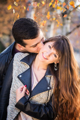 man woman couple kissing portrait sunny