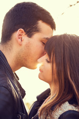 man woman couple kissing portrait sunny