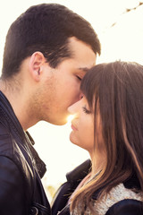 man woman couple kissing portrait sunny