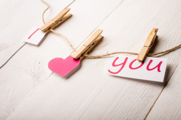 Valentines day card with hearts and words of love on old wood ba