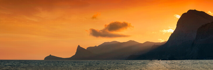 Panorama sunset on a mountain ridge in the sea