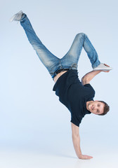 young break dancer showing his skills on white background.