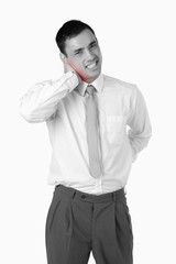 Portrait of a young businessman having a back pain