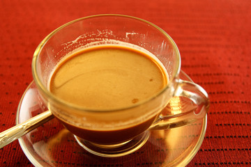 Cup of coffee on the table in red.