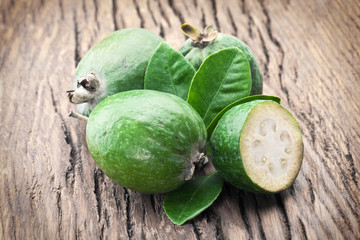 Feijoa fruits on old wooden table.