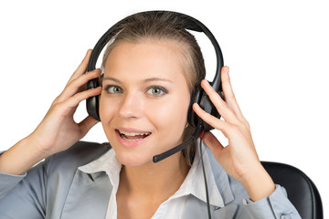 Businesswoman in headset, looking at camera