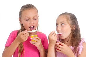 happy girls eating yogurt
