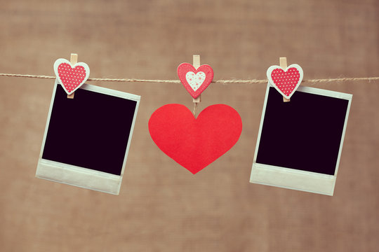 Two polaroid photo frames and red heart for valentines day on vi