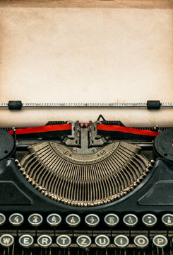 Fototapeta Antique typewriter with aged textured paper sheet