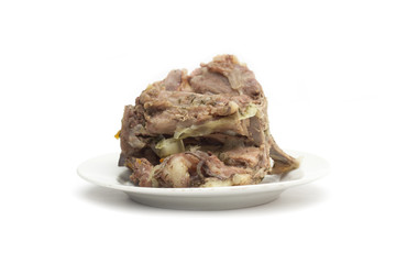 Bone with meat on a plate. Photo.