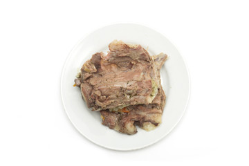 Bone with meat on a plate. Photo.