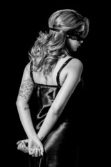 Fototapeta premium Blindfold woman with hands behind her back black and white