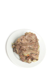 Bone with meat on a plate. Photo.