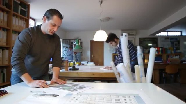 two architects  sketching plans