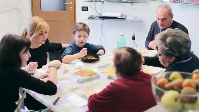 happy Italian family eating spaghetti for lunch