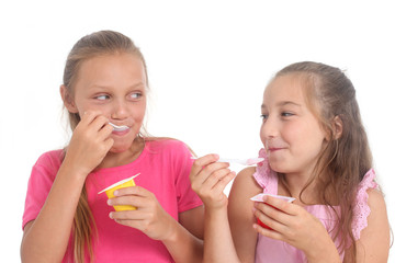 happy girls eating yogurt