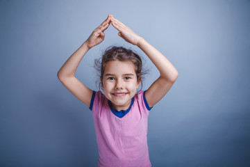 baby girl of European appearance 6 years hands above his head on