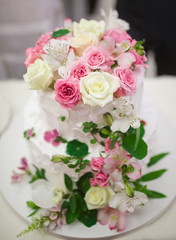 Wedding cake decorated with beautiful flowers.