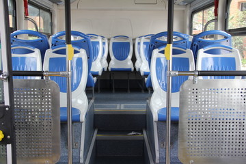 Blue and grey seats, Interior of a modern empty city bus,