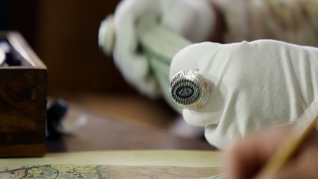 White gloves counting the bank notes and storing them into the shrine