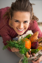Portrait of happy young housewife with shopping bag