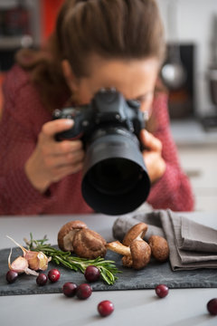 Closeup on female food photographer taking photo