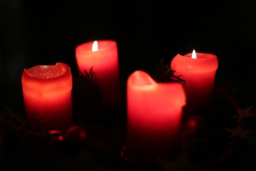 Four red christmas candles with selective focus effect