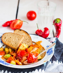 steamed vegetables on the plate with bread, vegan
