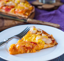 slice of pizza with chicken, corn, tomatoes and double cheese