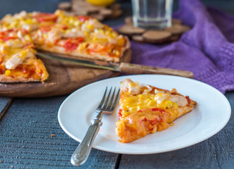 slice of pizza with chicken, corn, tomatoes and double cheese