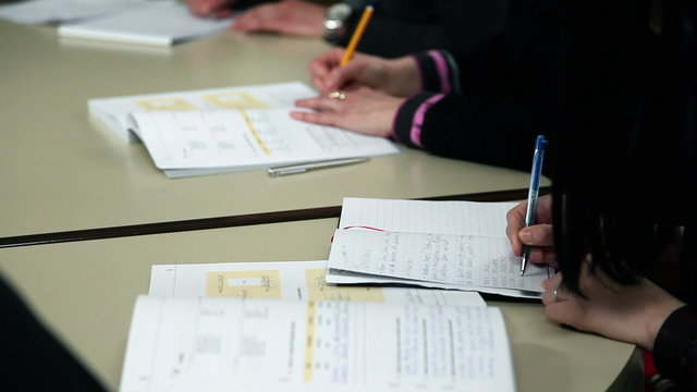 Students writing after teacher dictation