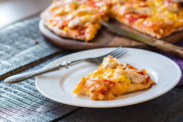 slice of pizza with chicken, corn, tomatoes and double cheese