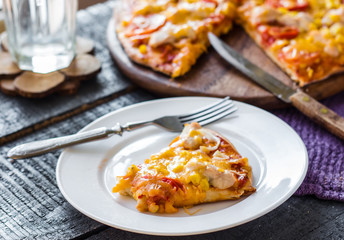 slice of pizza with chicken, corn, tomatoes and double cheese