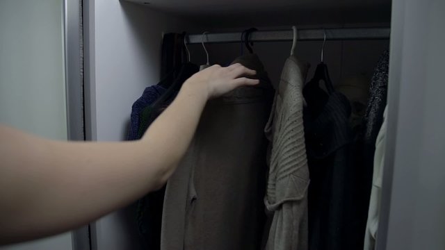 Woman hand choosing what to wear